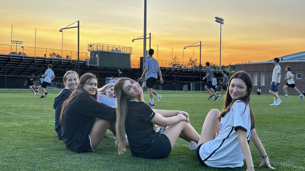 Girls on soccer field at sunset